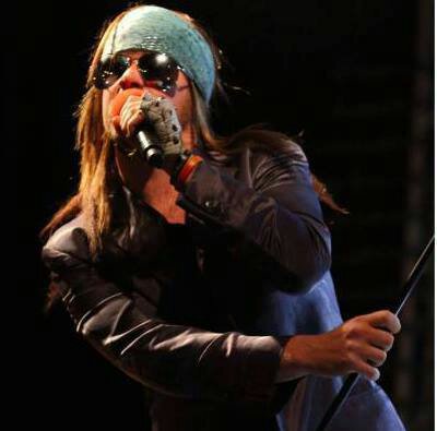 Gavin Felvus on stage as Axl Rose