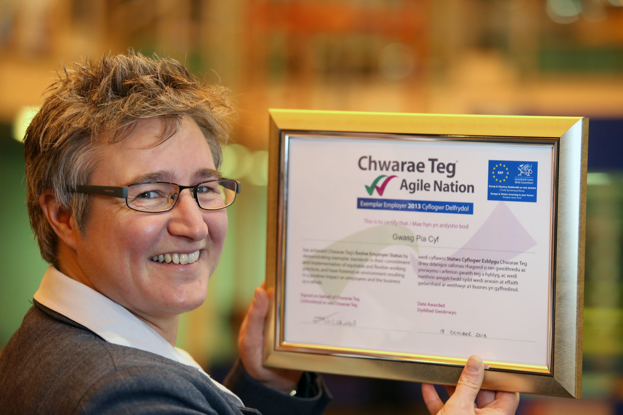 Managing director of Gwasg Pia Cyf Sharon Williams with her award from Chwarae Teg