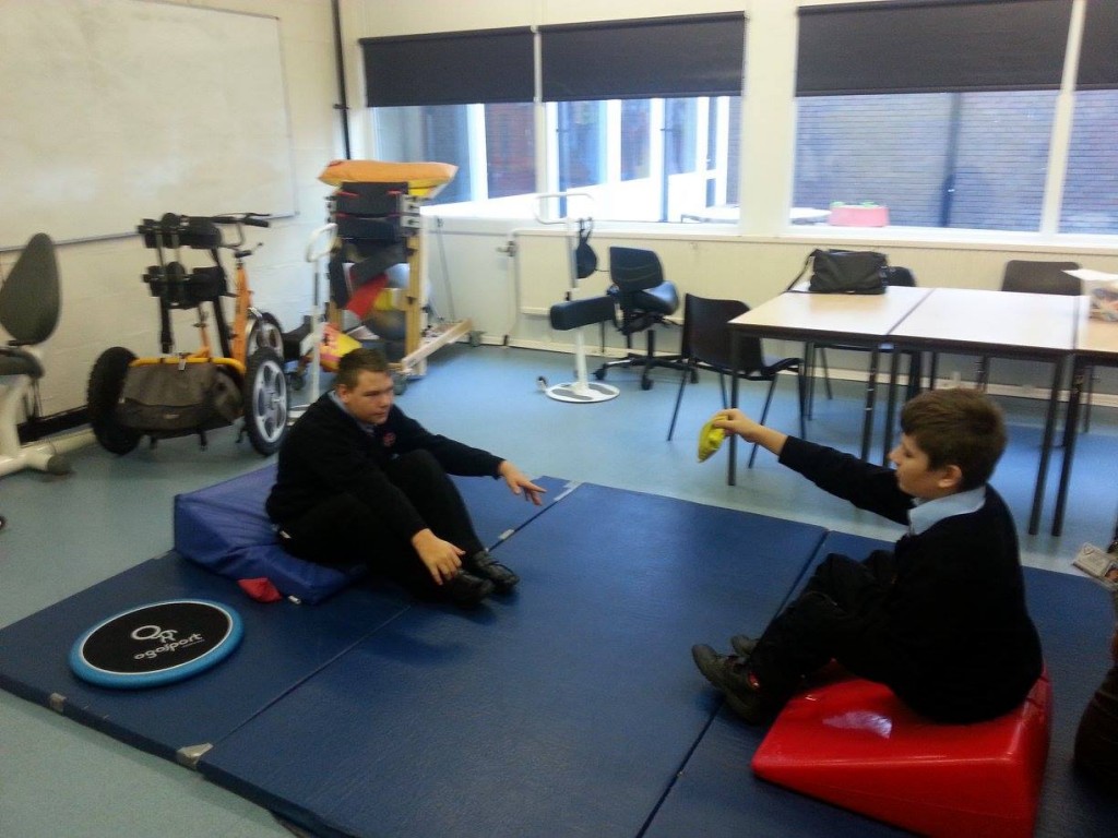 Kyran Bishop and James Vodden sat on ‘wedges’ which gives them good support and balance while playing tennis. 
