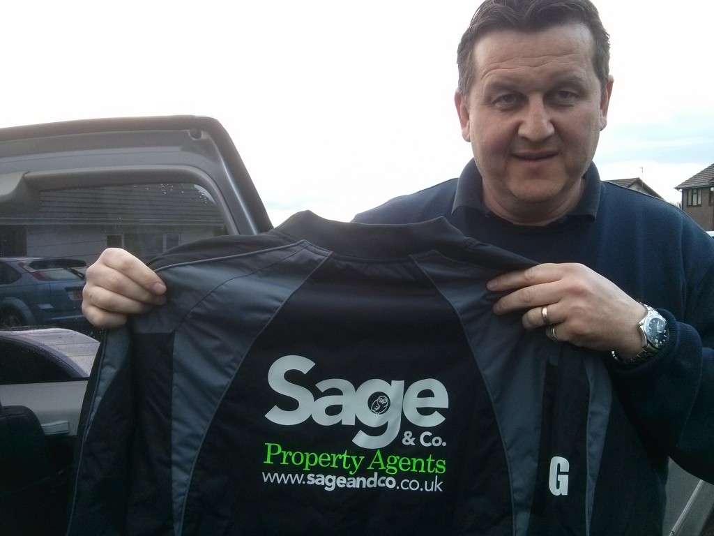 Danny Evans with one of the new training tops kindly sponsored by Sage and Co estate agents 