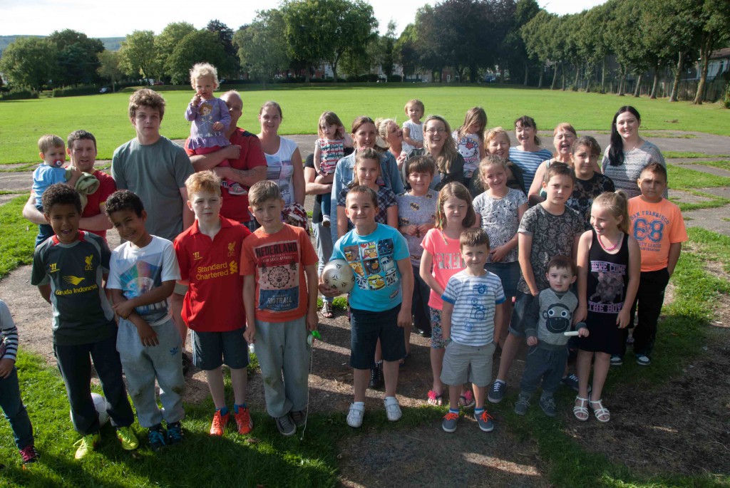 Local parents and children celebrate on the site of the new park