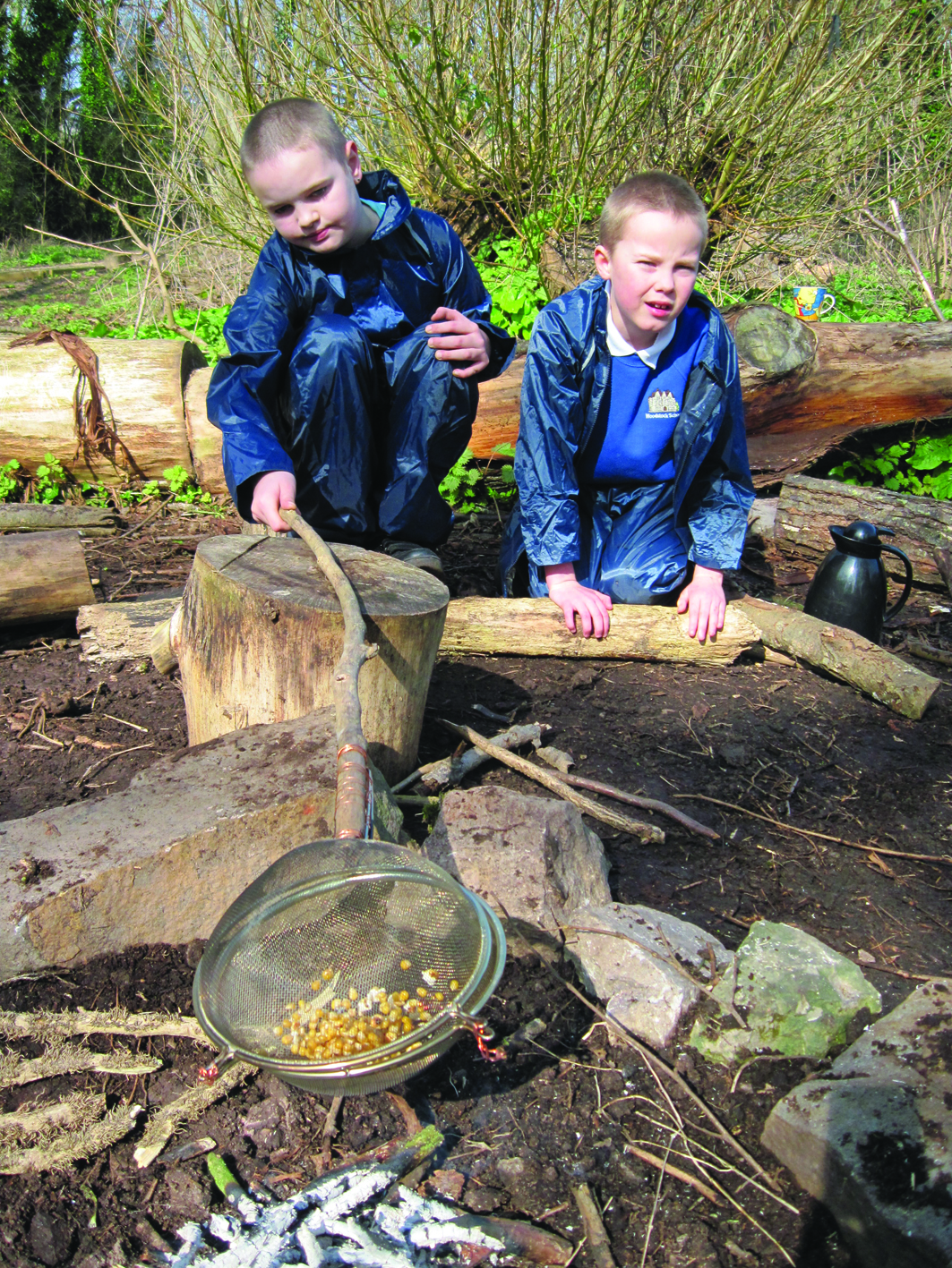 Using sticks to cook popcorn at Lawrence Weston Community Farm, Bristol