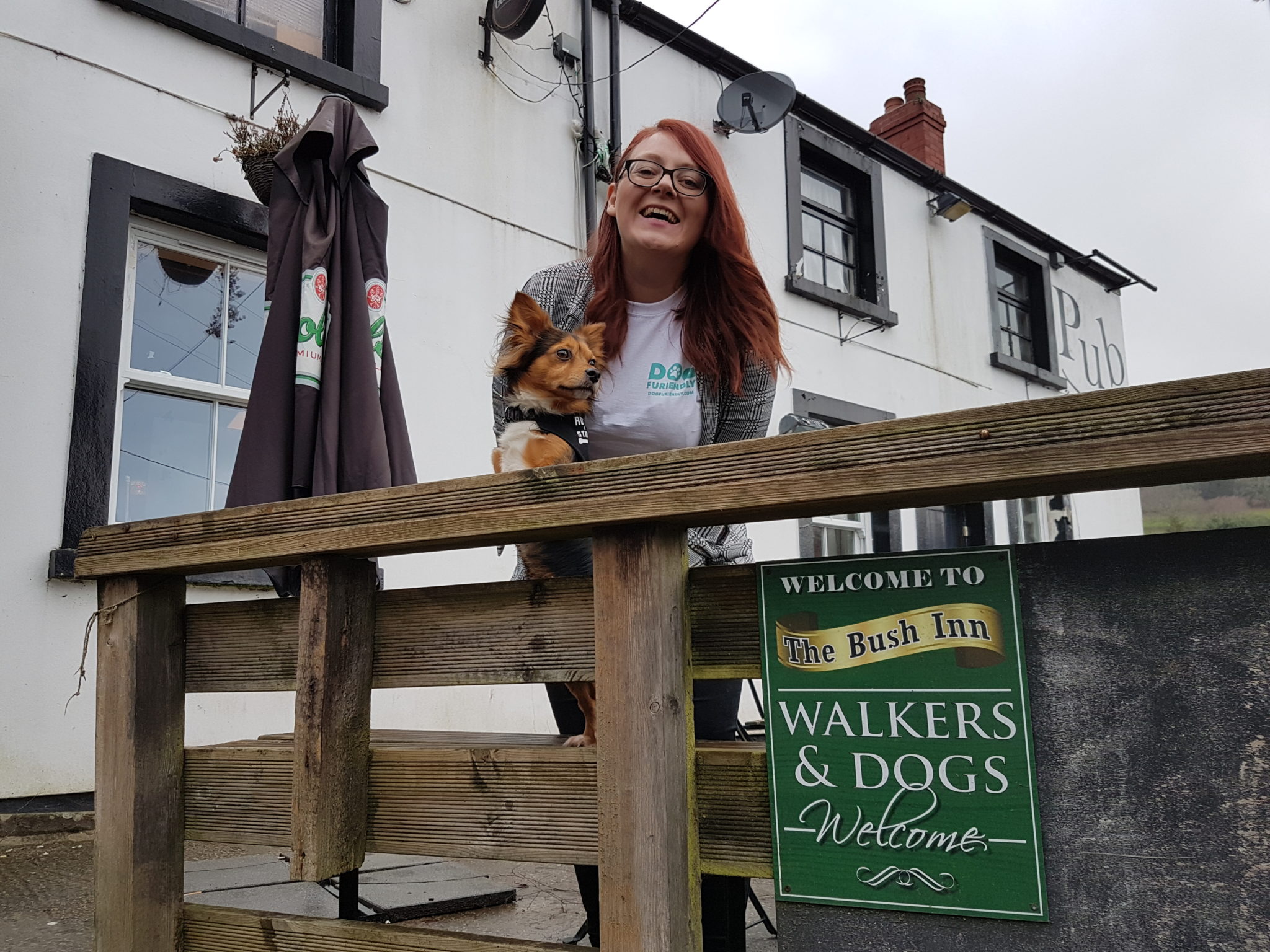 A dog owner with her pet outside a pub