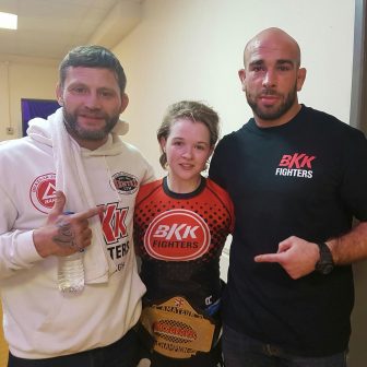 MMA fighter Cory McKenna with her coaches from BKK