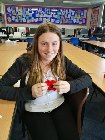 A Croesyceiliog School pupil with the poppy she knitted