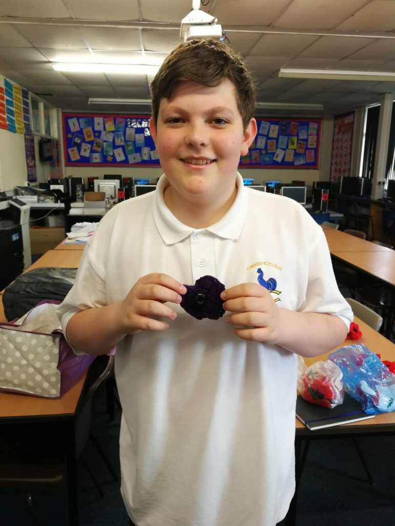 A Croesyceiliog School pupil with the poppy he knitted