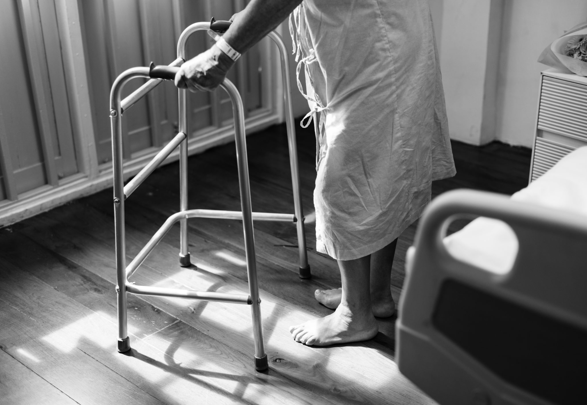 A person using standard walker inside room