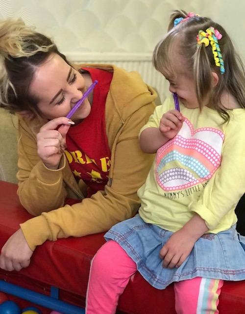 A child and playworker at one of the Torfaen Easter playschemes