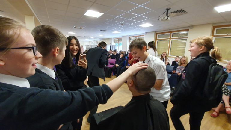 Owain's classmate piled around him after his head was shaved off