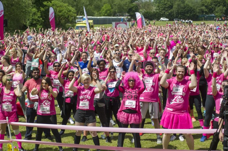 Crowd with men warming up at Race for Life