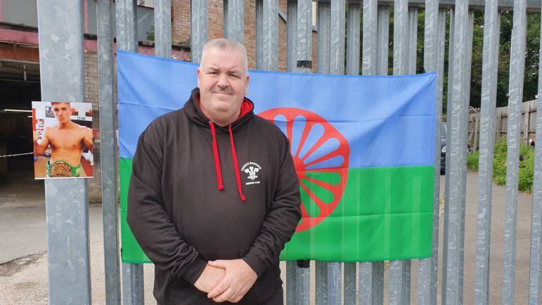 Simon Weaver, head coach at Torfaen Warriors ABC, outside his gym next to a photo of Shane