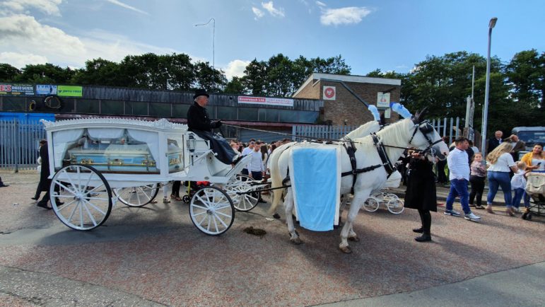 Shane Thomas' hearse being led by horses