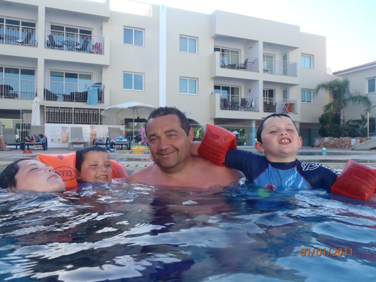 Jerry in a pool with three of his grandsons