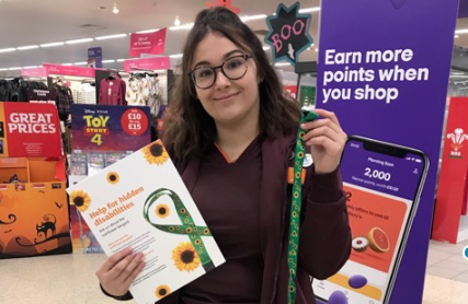 A staff member in Cwmbran Sainsbury's with a sunflower lanyard