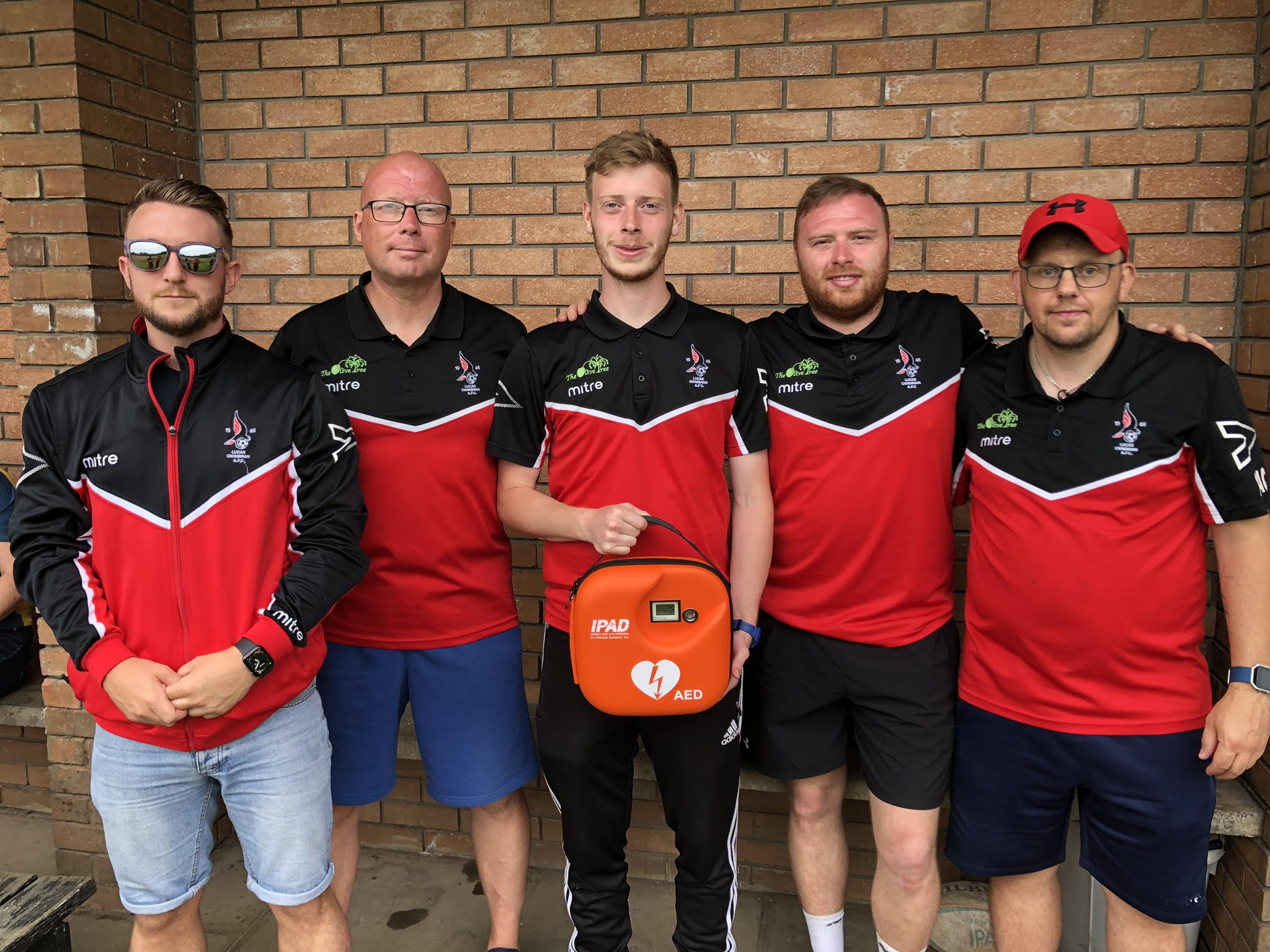 Members of Lucas Girling FC with the defibrillator that has been stolen