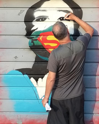 Lyndon Reynolds working on his mural