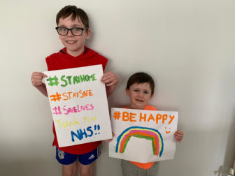 Two children holding posters for the NHS