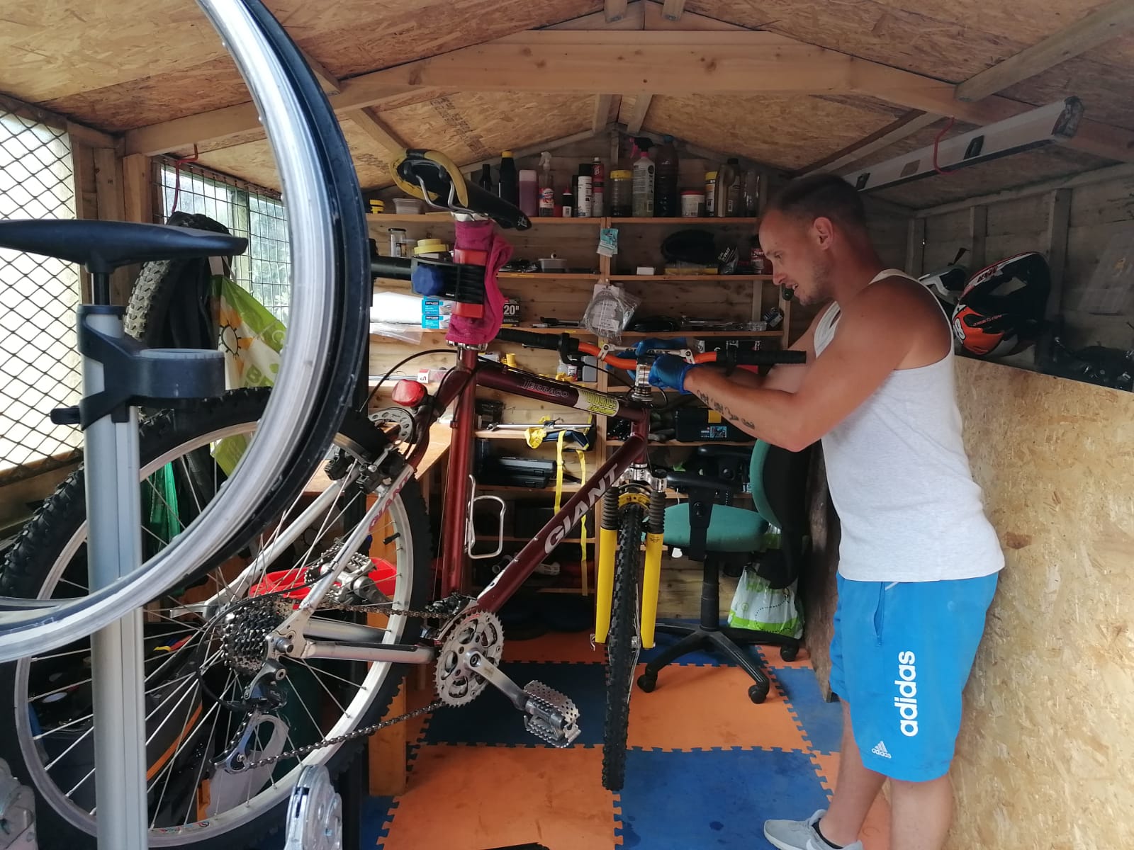 Nathan Shephard fixing a bike in his shed