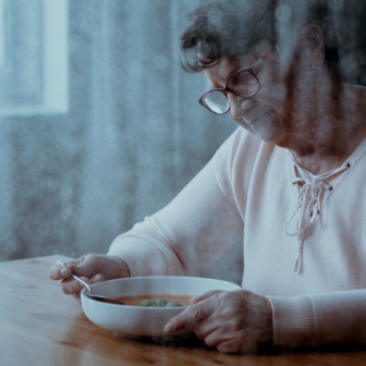 A woman aged over 75 eating soup