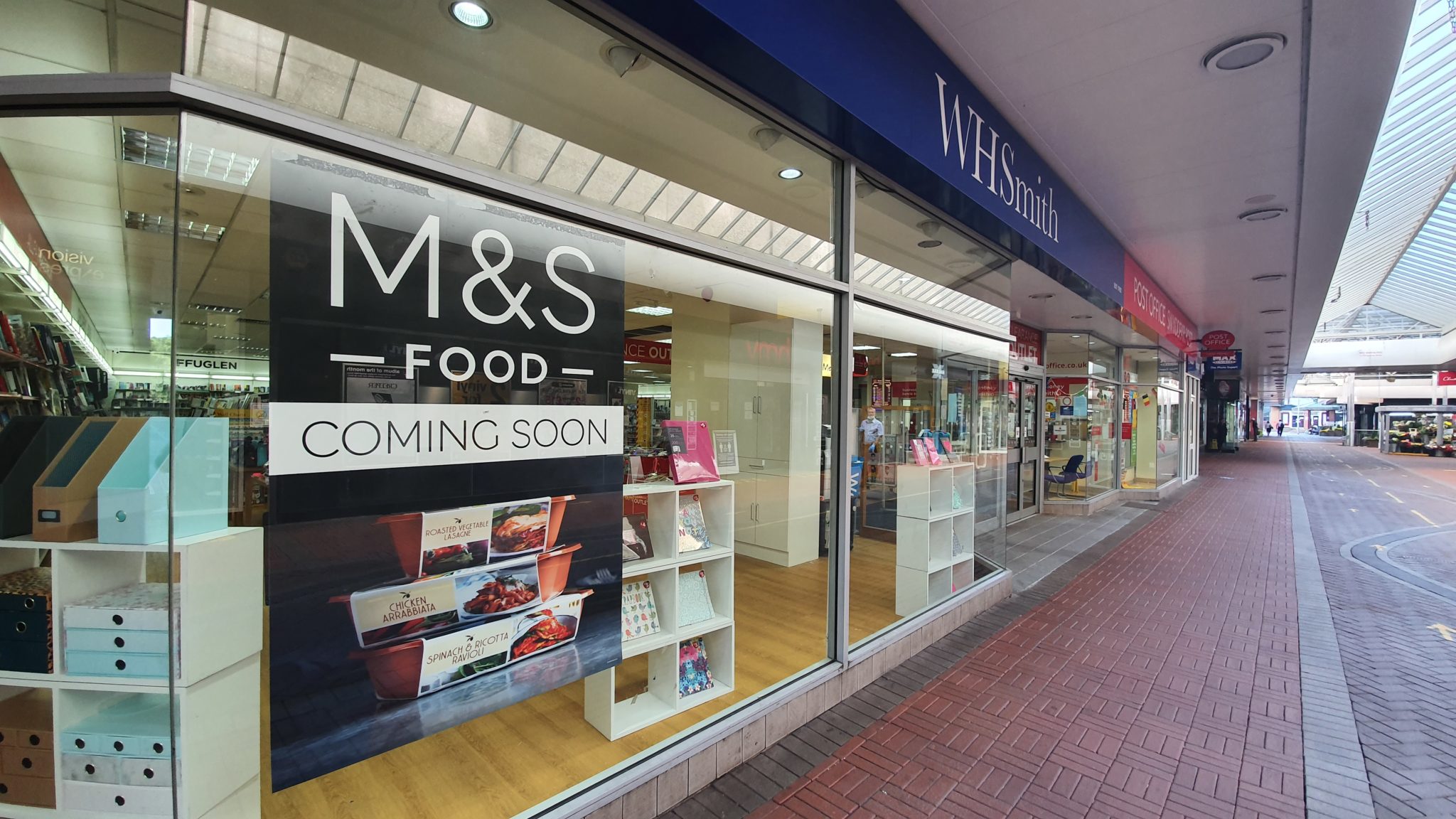 A poster in the window of WMSmiths to announce a M&S Food Hall is coming to Cwmbran