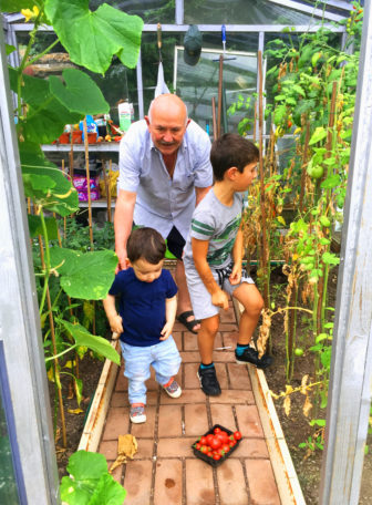 Joe and his grandsons in his greenhouse