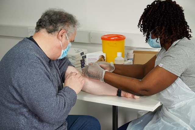 A nurse taking blood from a patient