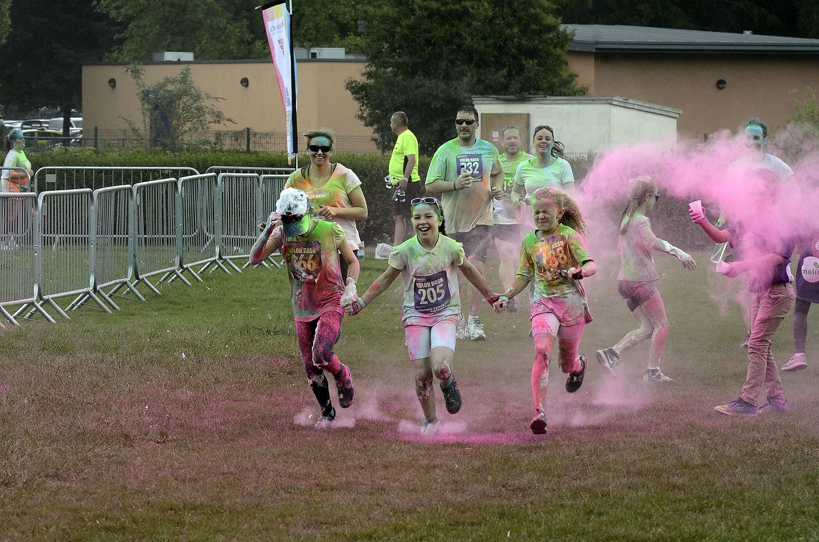 Three children cross the finish line at Kolor Dash in Newport