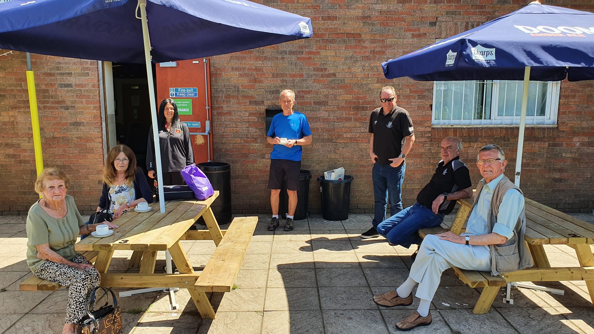 Members sat on pub benches