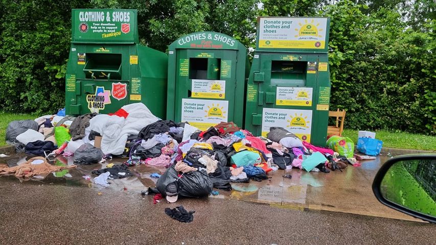 Clothes dumped by a recycling bank in Morrisons car park in Cwmbran
