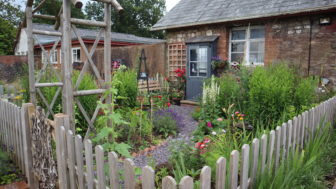 A garden next to a cottage