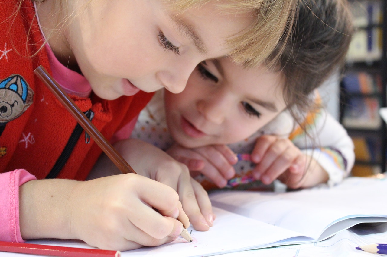 Children writing in a book