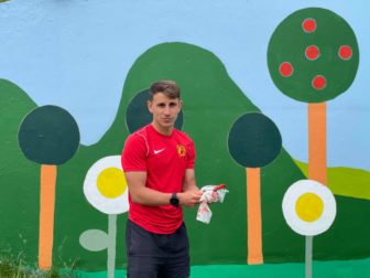 A man cleaning his paintbrush