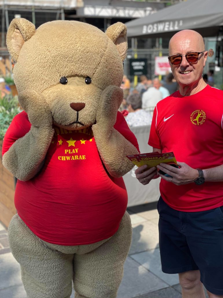 A man and a large toy bear