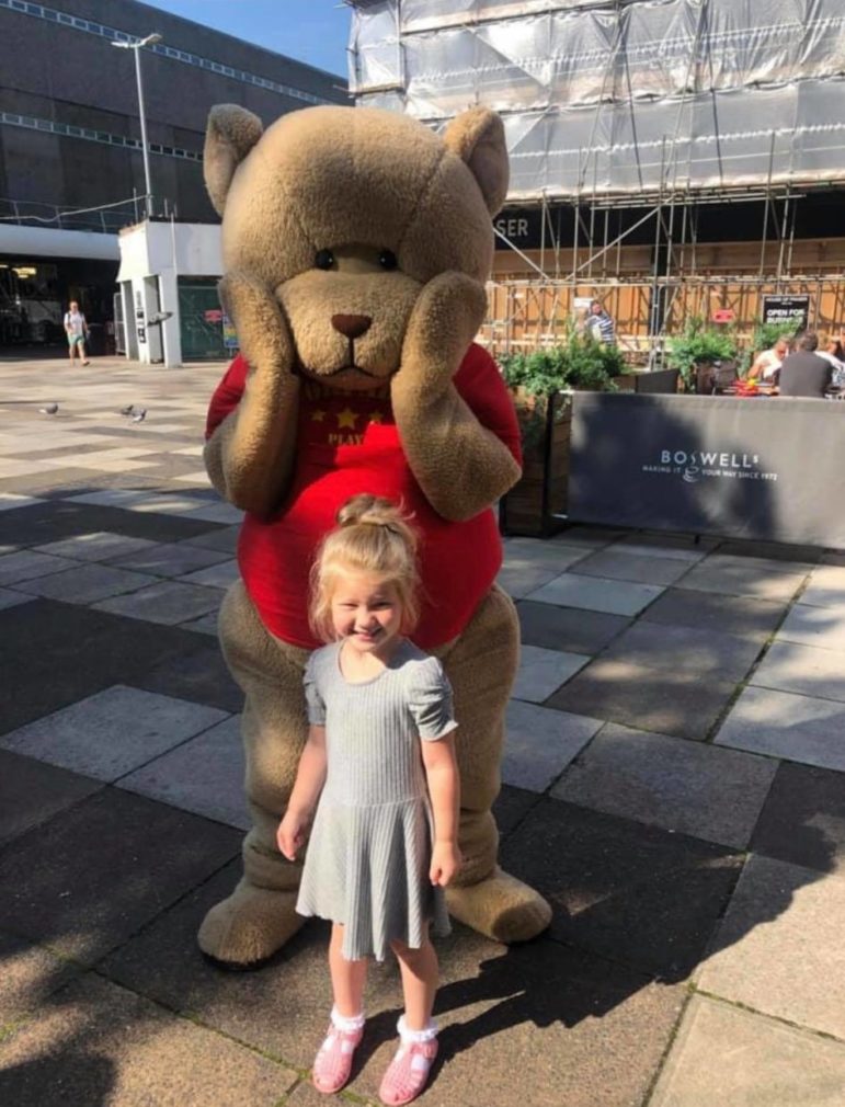 A child with a large toy bear