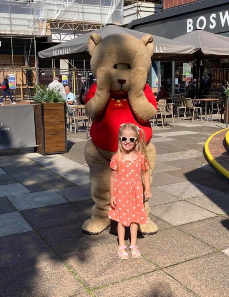 A child and large toy bear