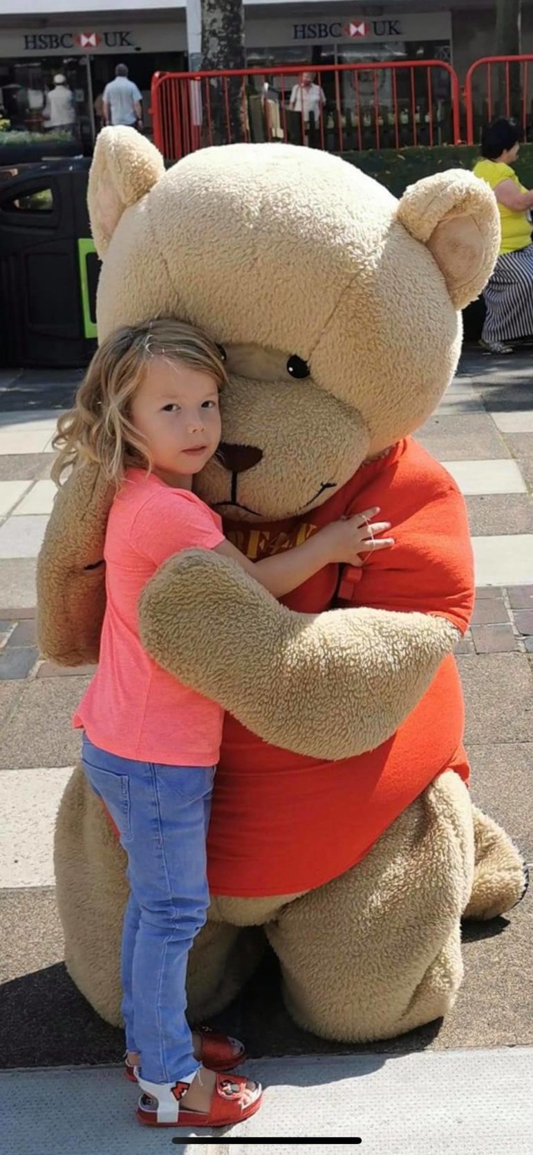 A child and a large toy bear