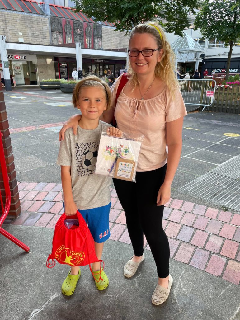 A family collect their playpack