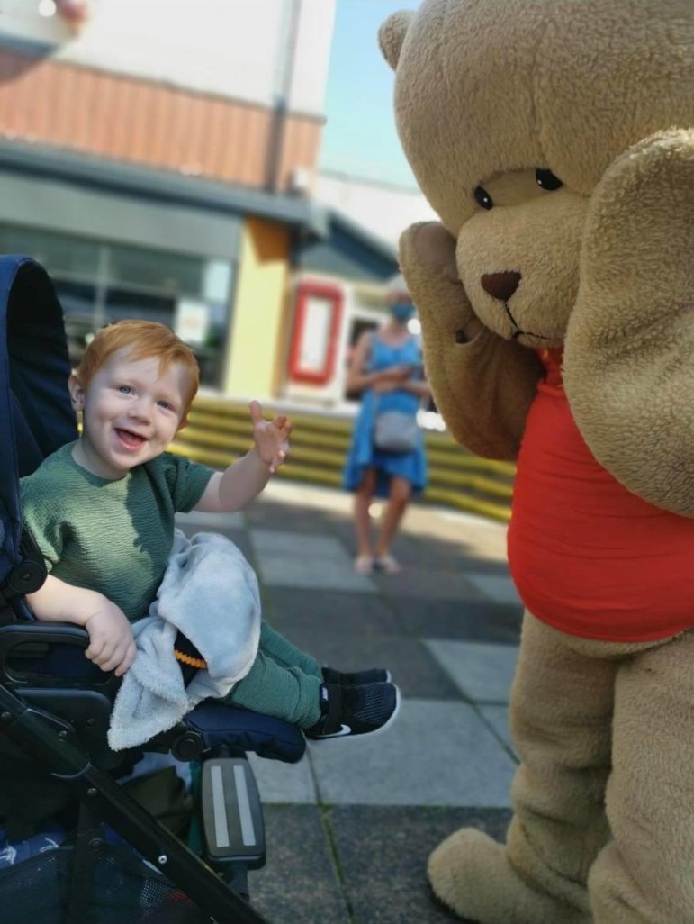 A child and a large toy bear