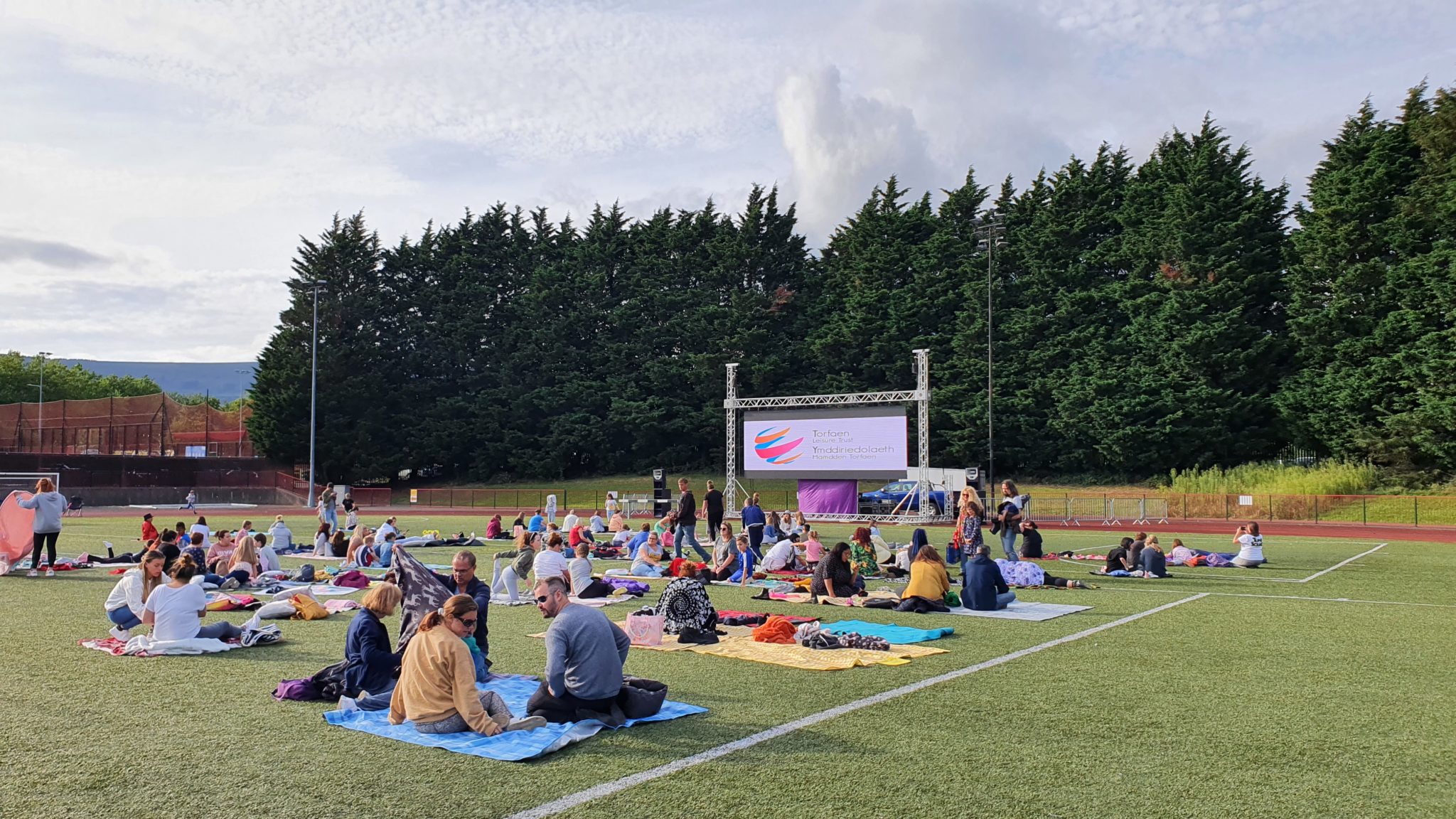 People sat on the 4G pitch at Cwmbran Stadium