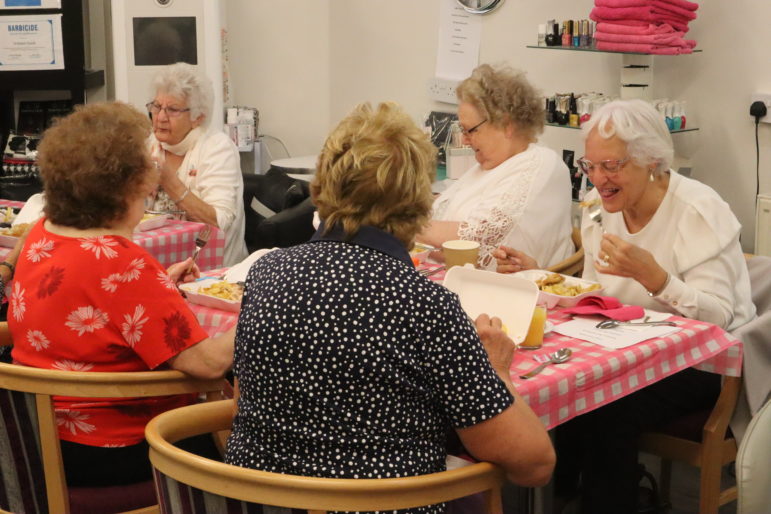 Women laughing at table