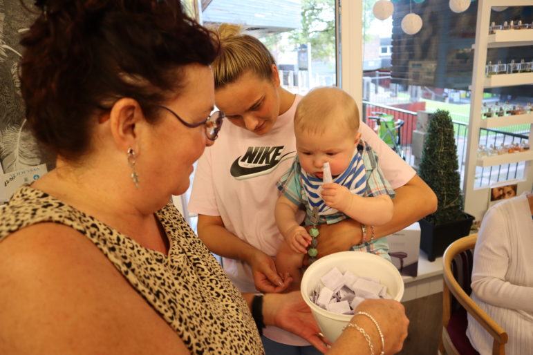 A baby with a raffle ticket