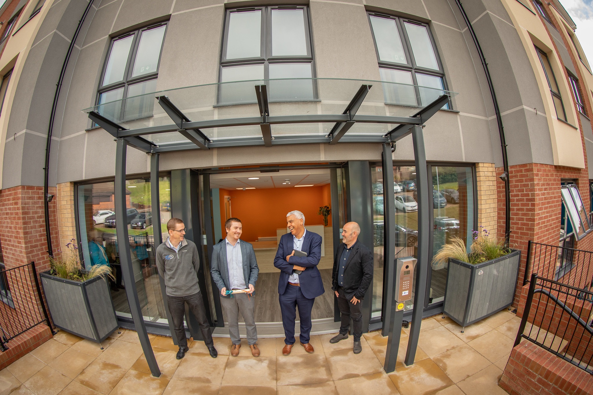 Four men stood at entrance to Staff inside Ty Glas y Dorlan