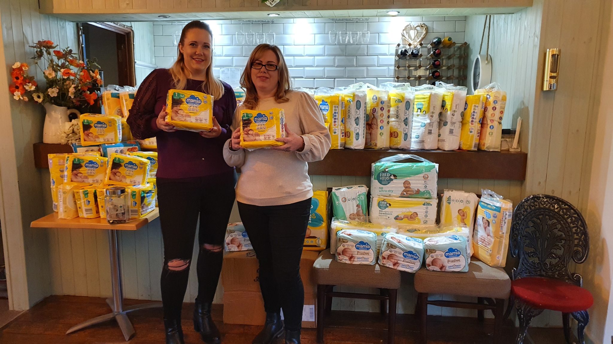 Porscha Hilton and Claire Davies holding nappies