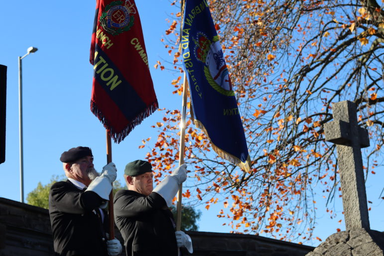 Two men holding flags