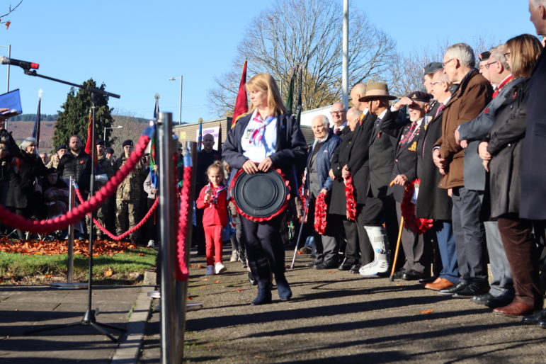 A woman laying a wreath