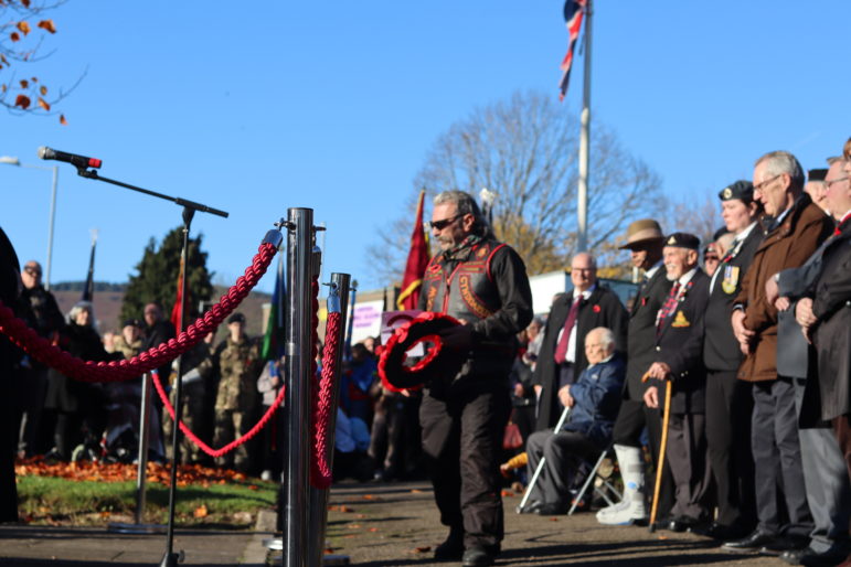 A man laying a wreath