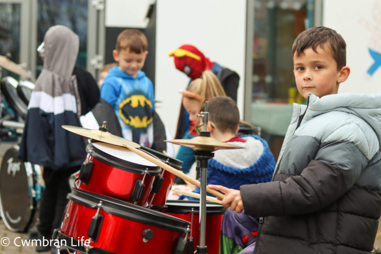 A boy plays the drums