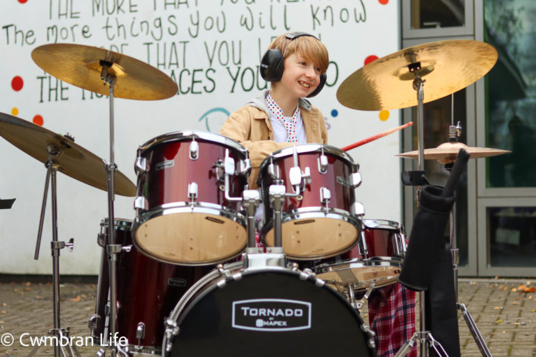 A boy plays the drums