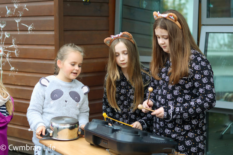 Three girls play the drums