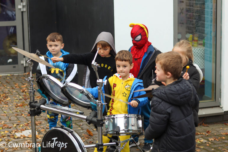 A boy plays the drums